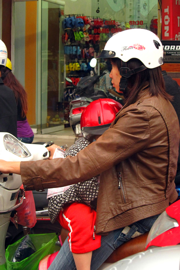 At least the kid's got a brain-bucket on.