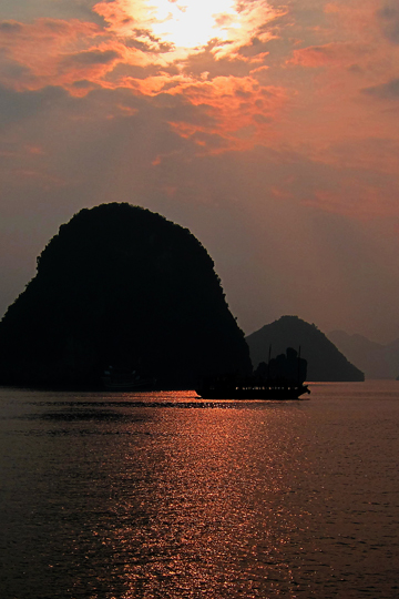 Sun silhouetting a ship.