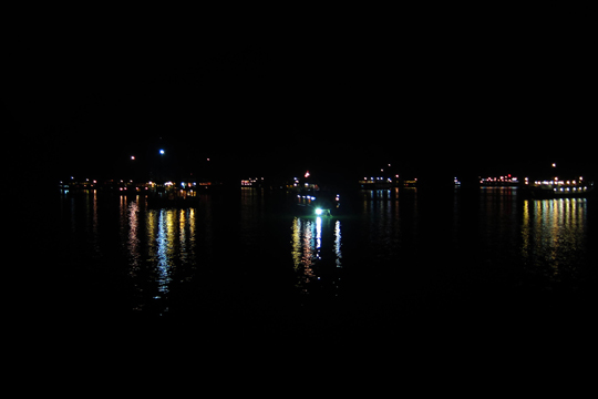 Tourist junks twinkling in the night.