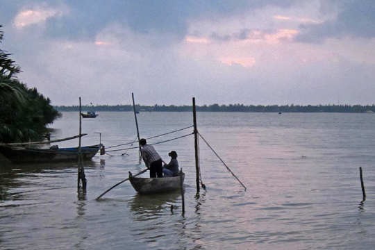 Fishers in the pre-dawn light, near Hoi An.