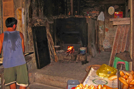 Wood-fired oven at bread bakery, Hue.