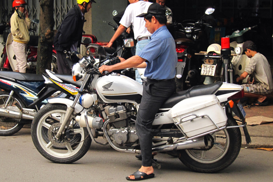 Police motorcycle at repair shop, Hue.