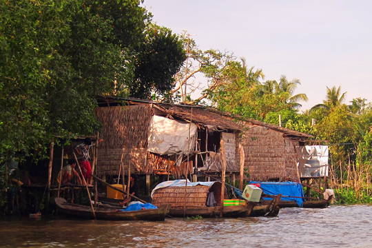Palm-frond huts on the Mekong, near Can Tho.