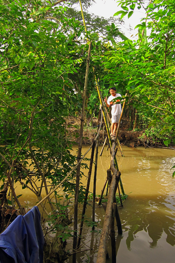 Huy on a traditional foot-bridge, near Can Tho.