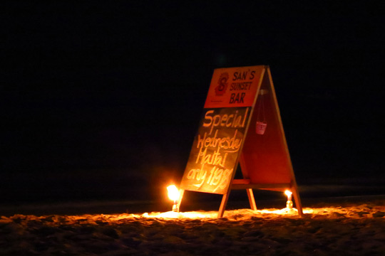 Beach sign for San's Sunset Bar.