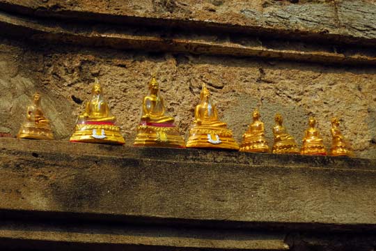 Offerings of small Buddha statues.