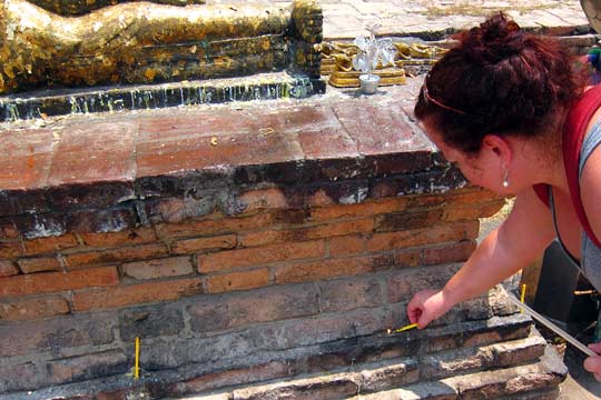 Eron leaving a candle at Wat Lokayasutha.