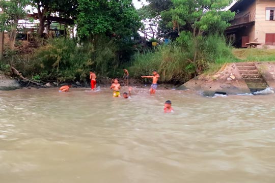 Kids playing in the river.