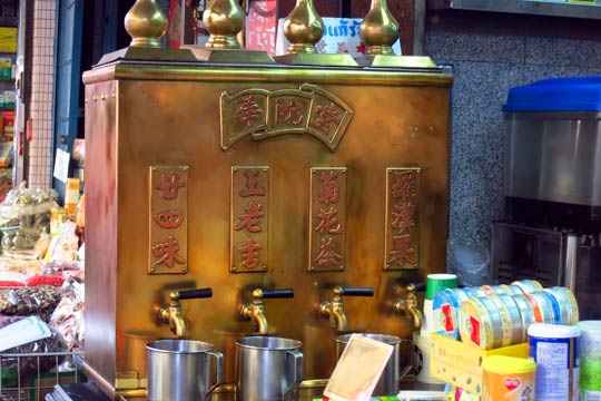 Brass tea dispenser at a tea shop.