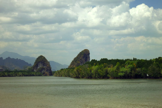 Rock formations and mangrove swamps acres the Krabi River.