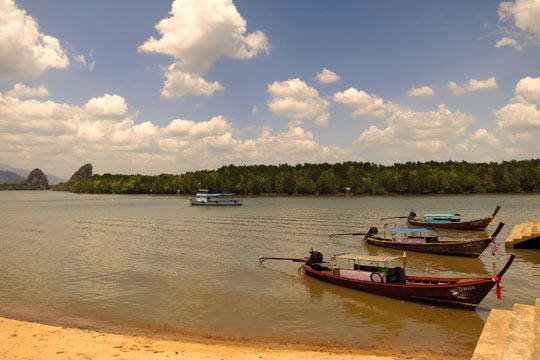 Longtail boats tied up on the Krabi River.