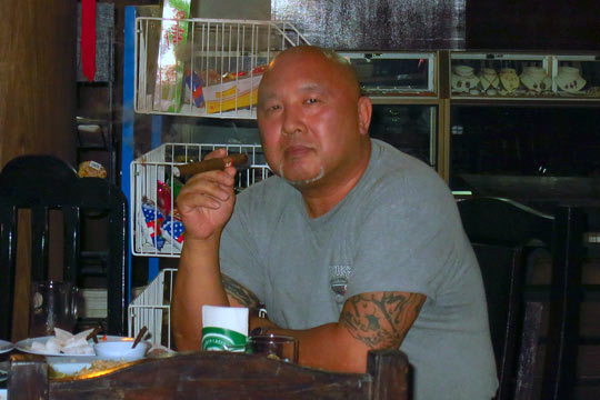 After-dinner cigar at the dinner table.