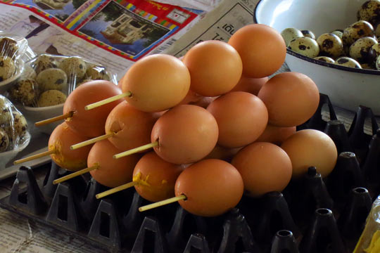 Hard-roasted eggs on a stick.