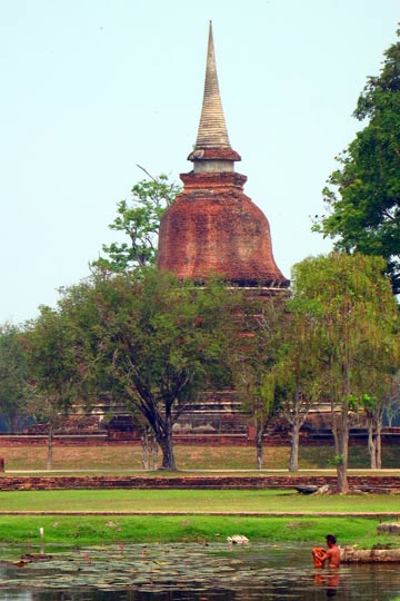 Man bathing in front of Chedi.