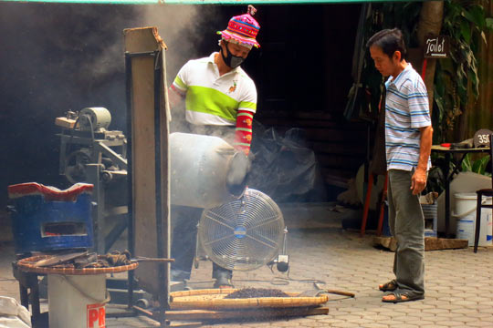 Pouring out the roasted beans.