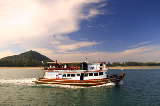 Smaller ferry also leaving port at same time.
