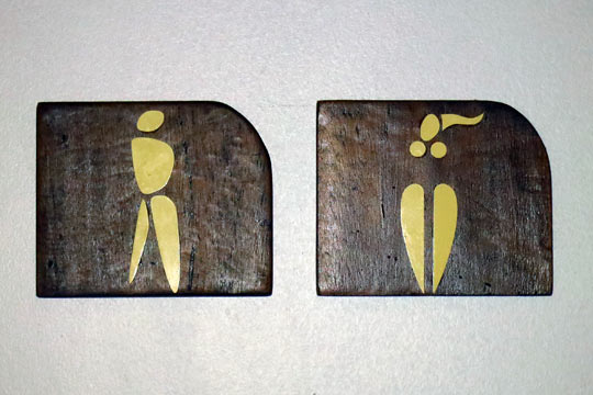 Signs for the Men's and Ladies' restrooms.