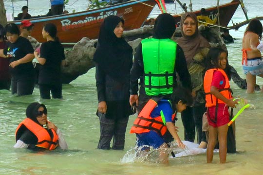 Muslims having fun in the sun and the surf.